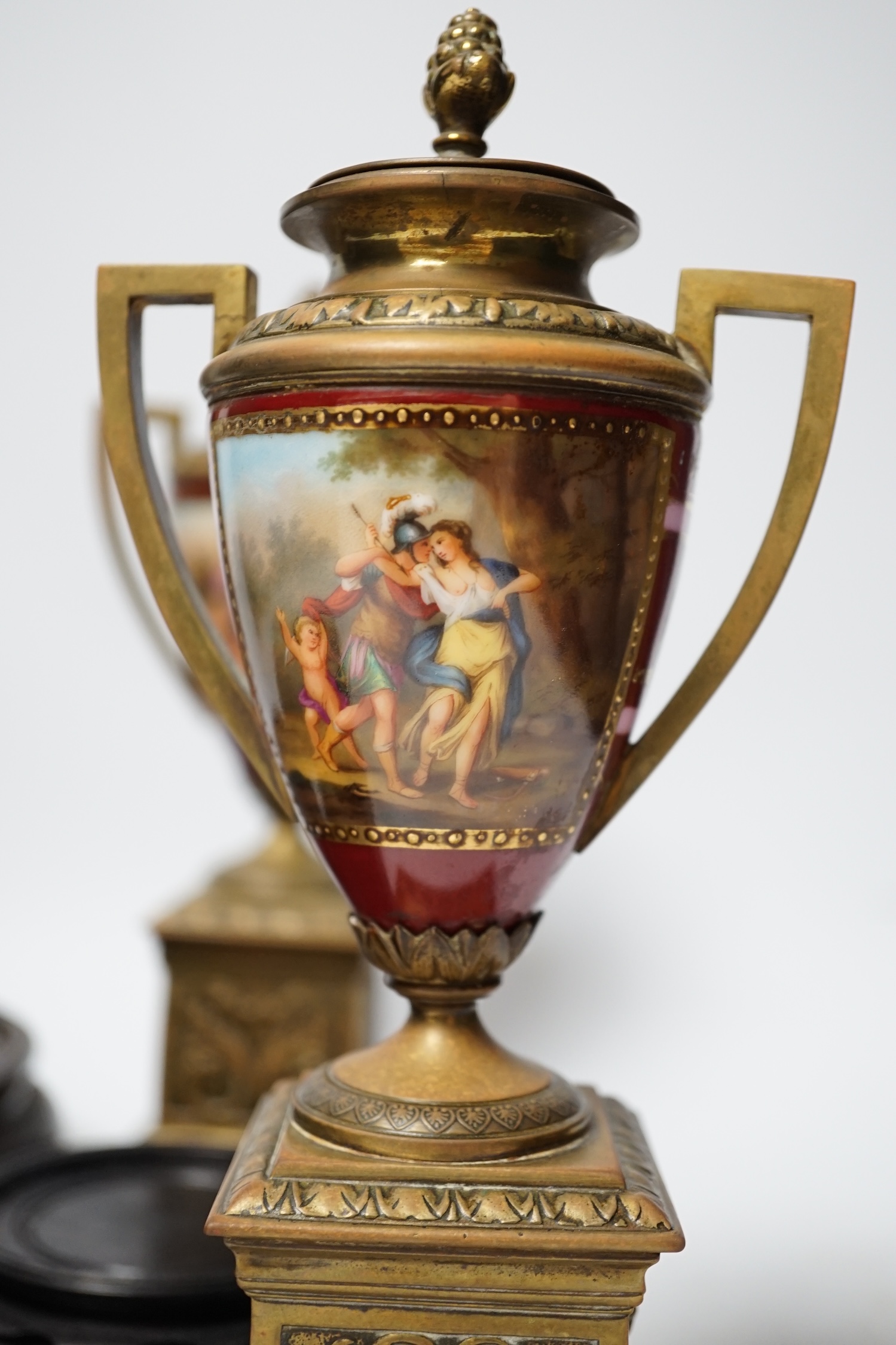 A pair of Vienna style brass mounted urns with enamelled classical scenes and six various Chinese carved hardwood stands, 23cm high